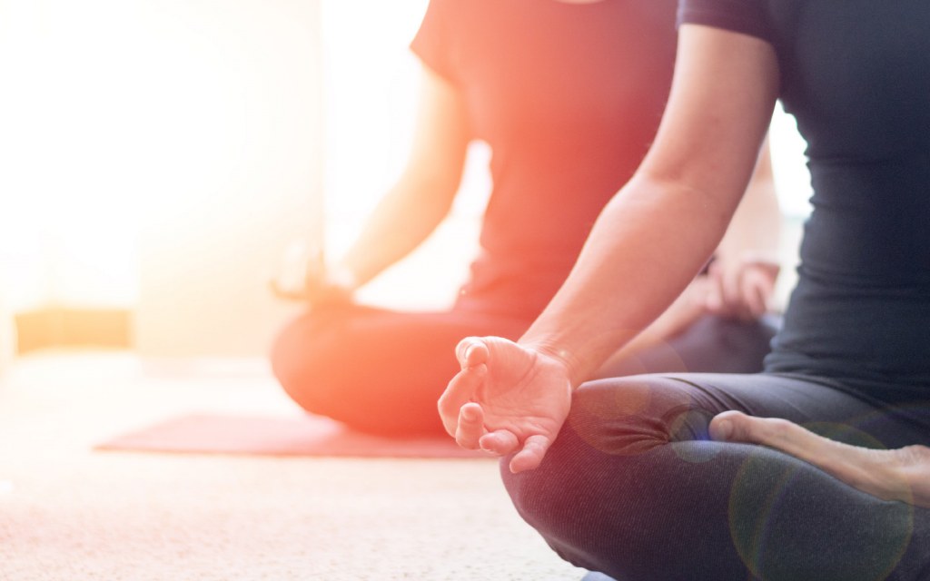 Woman meditating during yoga class