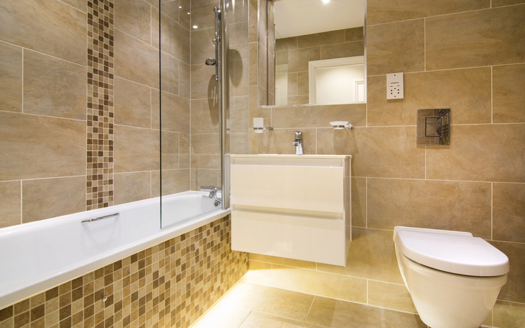 Stone tiles installed on bathroom floor and walls