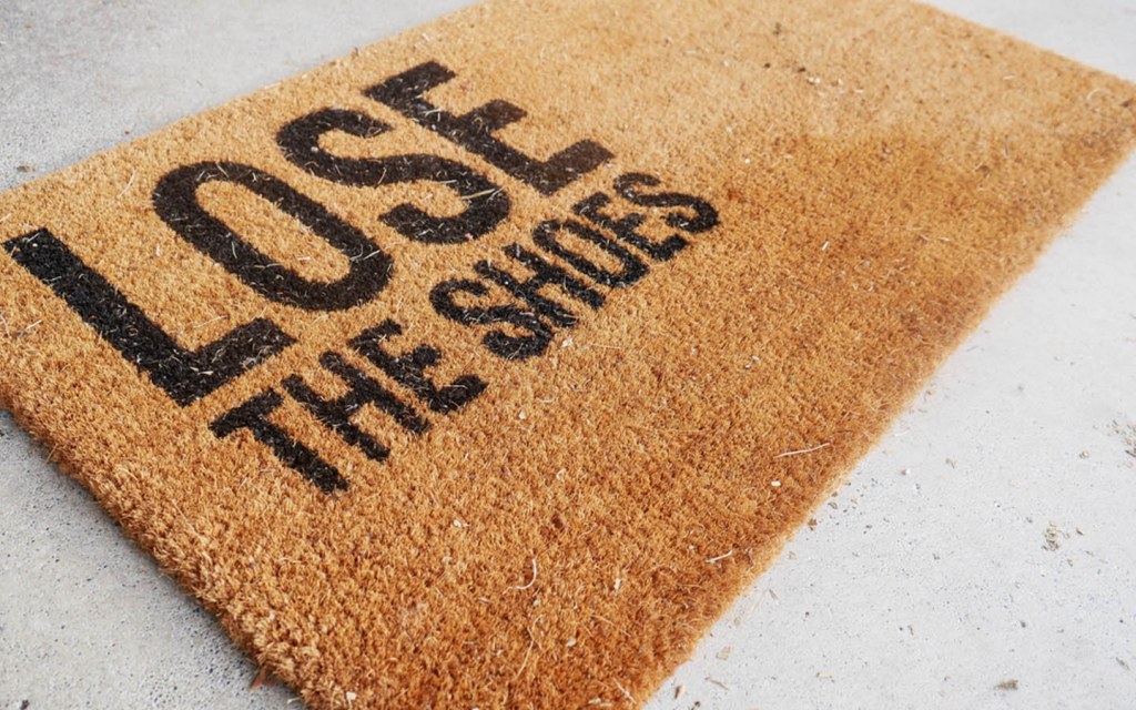 Rug that reads "lose the shoes"